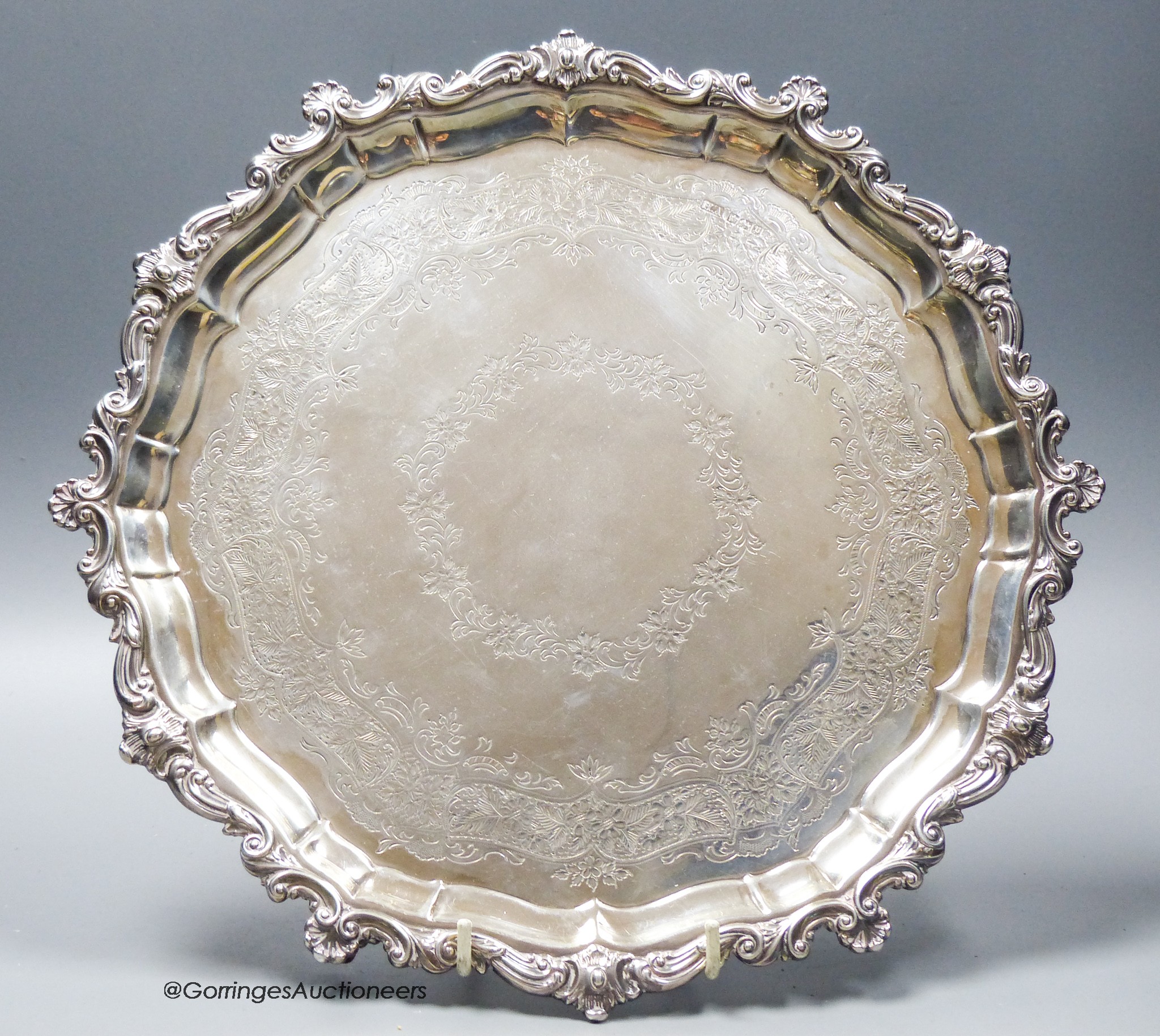 An Edwardian engraved shaped circular silver salver, with scroll border and later engraved inscription underneath, Atkin Brothers, Sheffield, 19907, 31.8cm, 23oz.